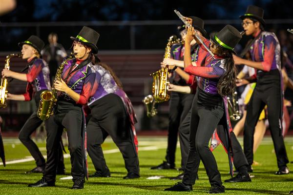 Ravenwood High band members march